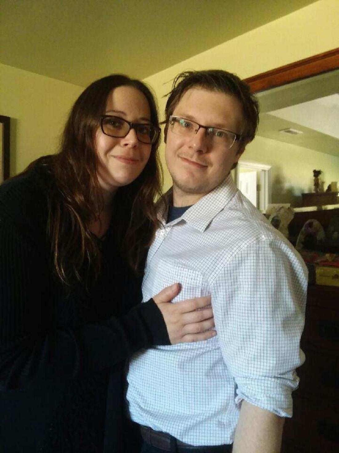 A happy couple looks into camera