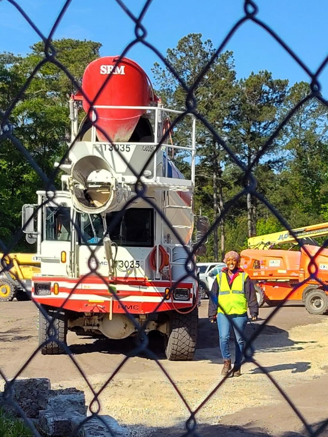 A woman driving a cement mixer