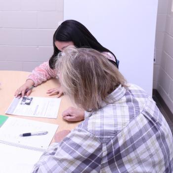 Tutor works with student to learn English