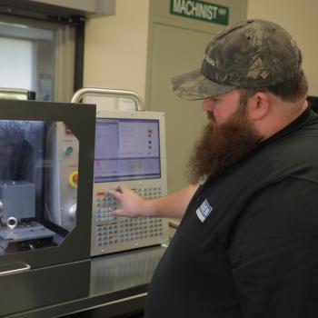 Computer-integrated machining instructor uses machine