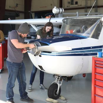 Students in the Havelock aviation program work on inactive planes in the hangar