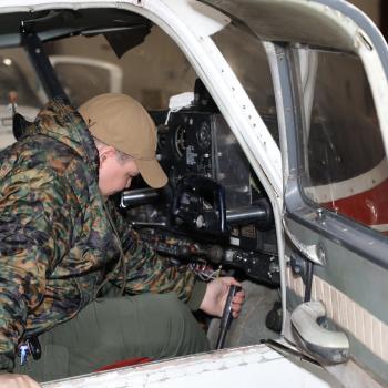 Male student works on inactive training airplane in FAA Airframe class on the Havelock campus