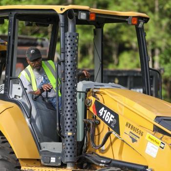 Heavy equipment student operates a backhoe during hands-on training.