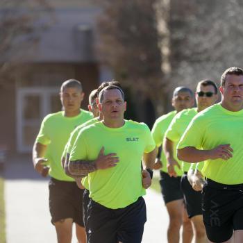 Basic Law Enforcement Training students run together outdoors during physical training.