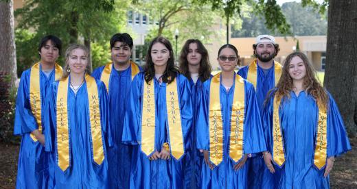 Group of 2025 student marshals in caps and gowns