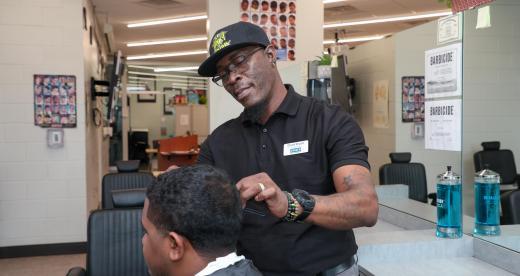 barber cuts a customer's hair