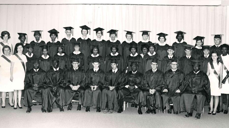 Black and white photo of graduates in caps and gowns