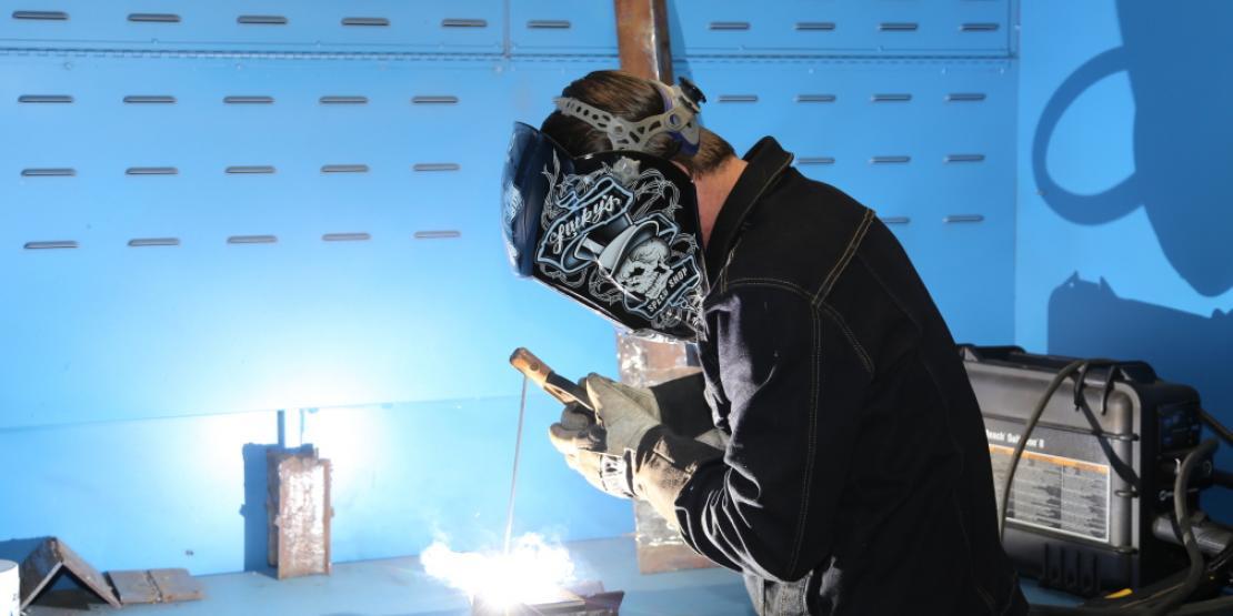 Craven Community College and Early College EAST student Zack Farnham works on a project at his welding booth in the college’s welding department. (Photo by Meredith Laskovics)