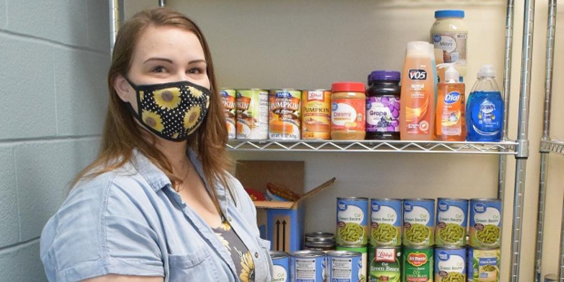 Craven CC student ambassador Leigh Anne Hollar stocks canned goods in the college’s Panther Pantry. The Campus Life department is holding a Thanksgiving Meal Drive through Friday, Nov. 20 for students and employees in need during the holidays.