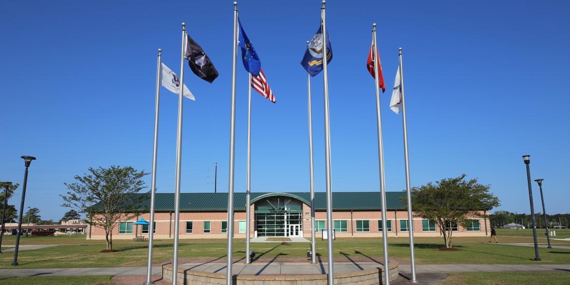 Havelock campus exterior with flags in courtyard