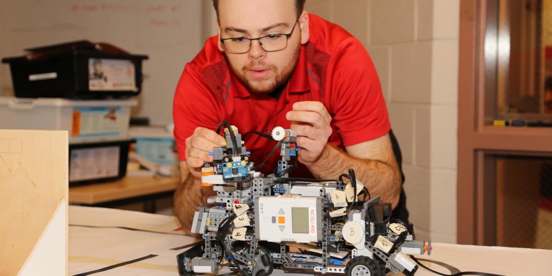 NC State Engineering program student tinkering with project