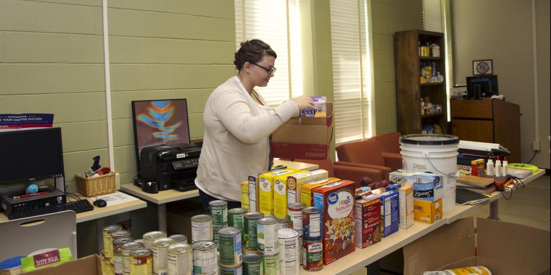 Craven CC student and Phi Theta Kappa member Paige Fike sets out donations for the food pantry and supply closet as part of a college-wide effort to assist Craven CC faculty, staff and students affected by Hurricane Florence.