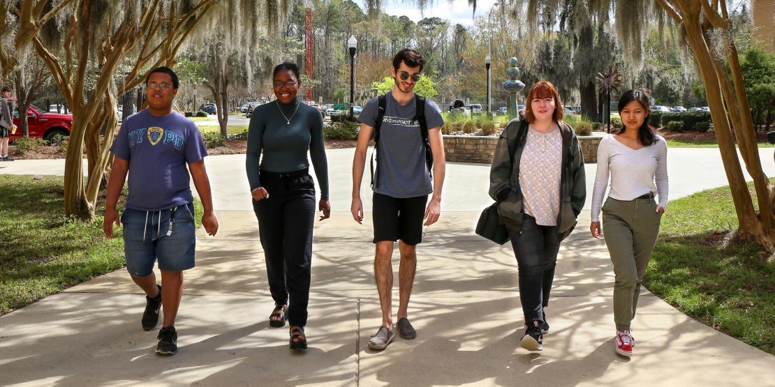 Five students walking outside