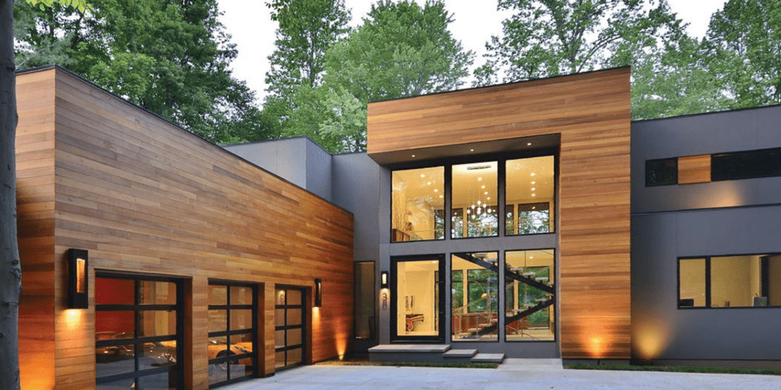 Large modern wooden house near woods