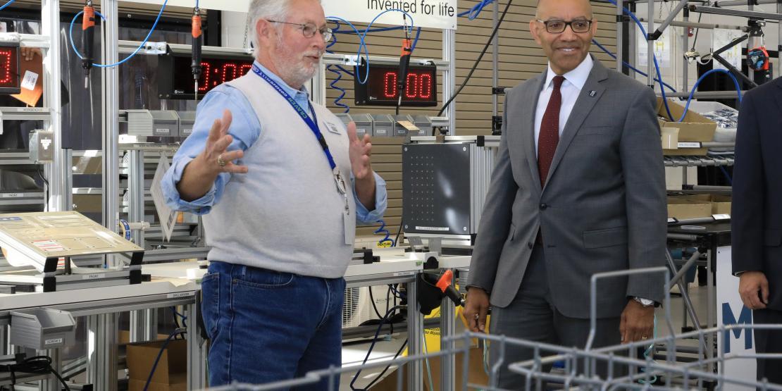 Instructor giving tour of assembly line