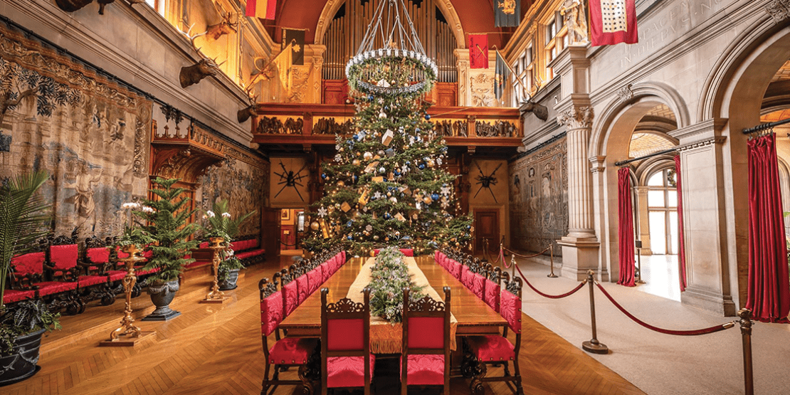 Interior view of banquet table and seating with Christmas décor inside the Biltmore Estate.