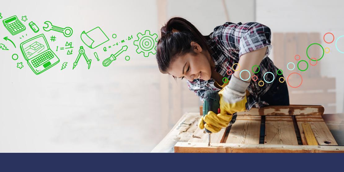 Female carpentry student drilling into a piece of wood