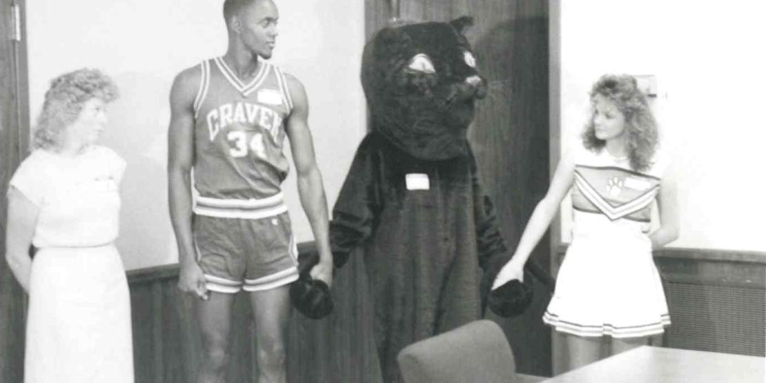 College female worker, male basketball player, black panther mascot, and female cheerleader