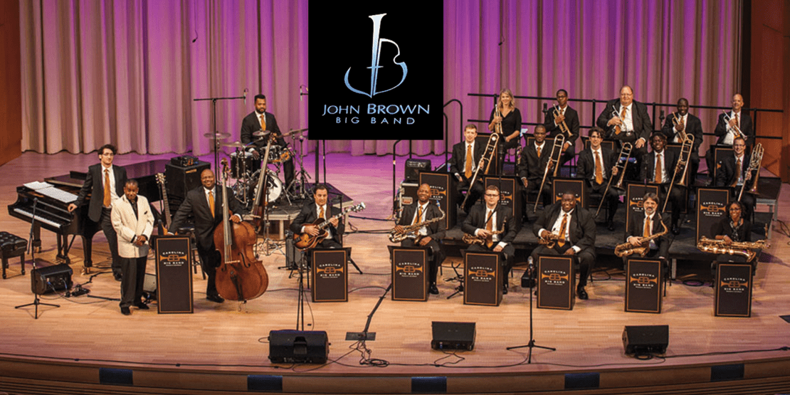 Band on stage in black suits with brass instruments