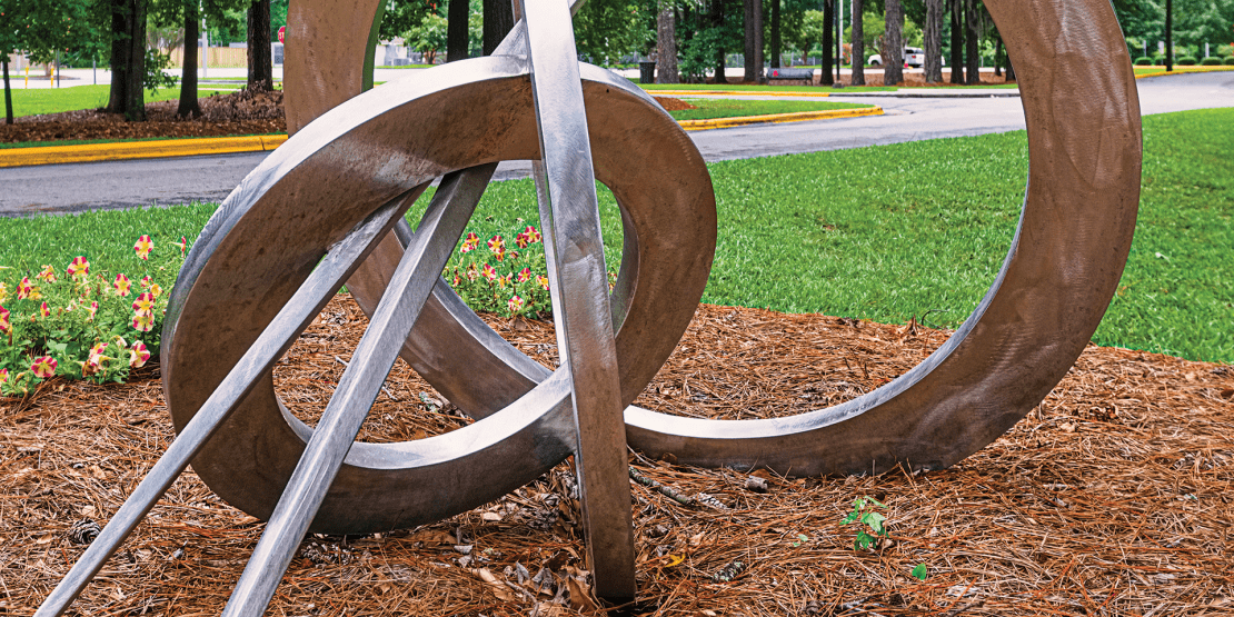 Silver stainless steel sculpture with circles and lines