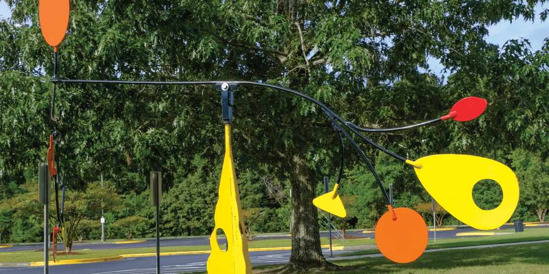 Yellow, orange, and red painted iron sculpture