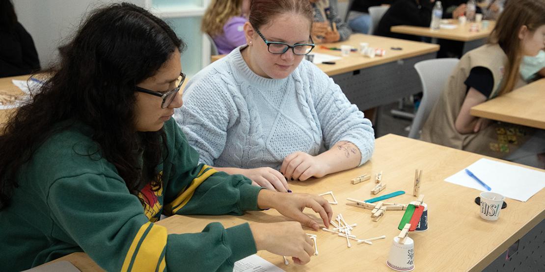 Students work with Q-tips during a STEM event