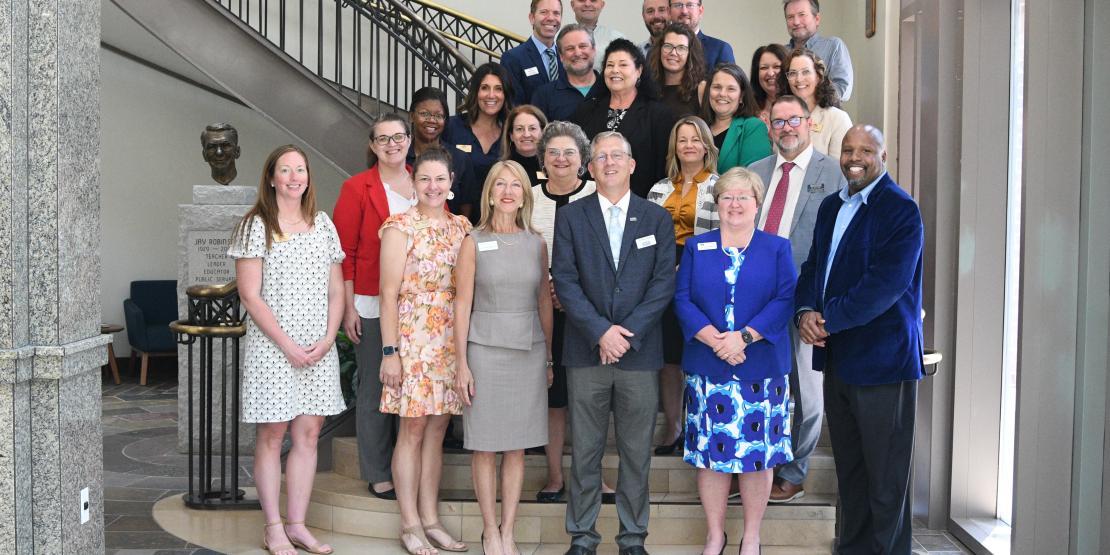 Group Photo in front of staircase