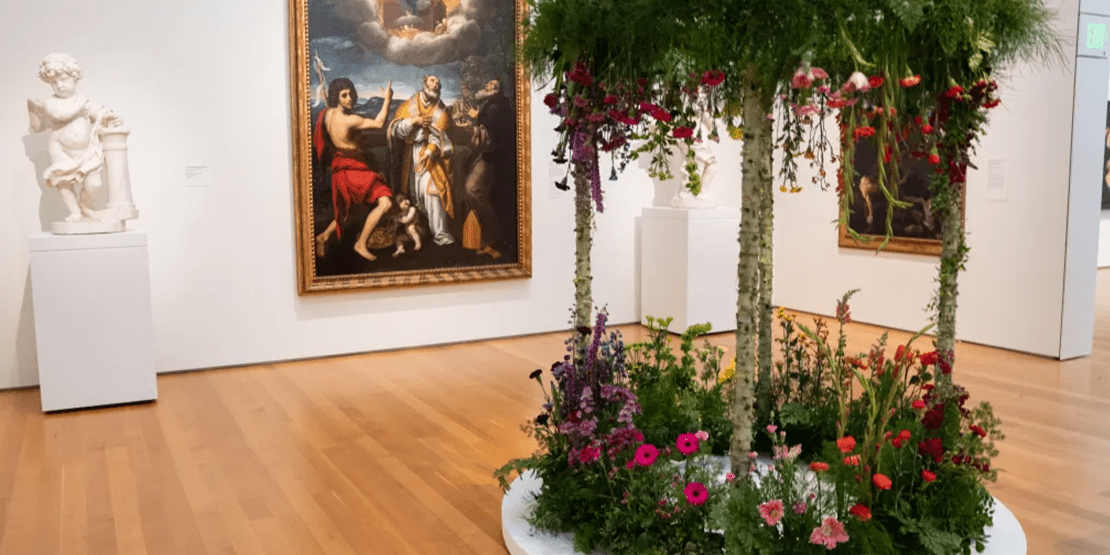 Statue, flowers, and art in a gallery