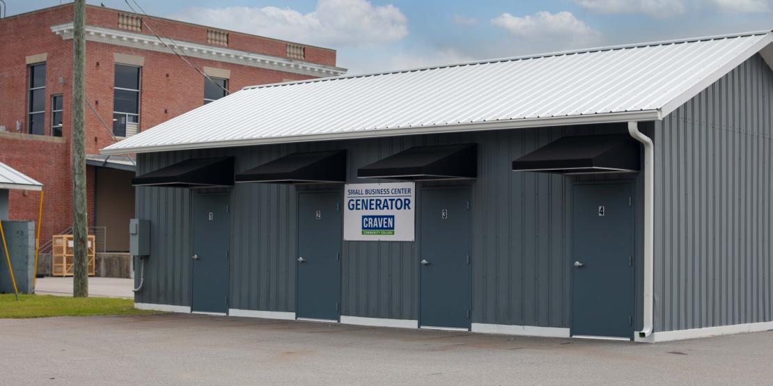 Exterior of a metal building with four doors