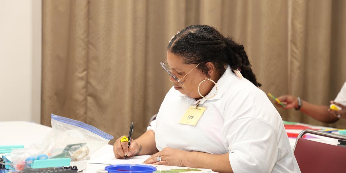 woman sits at a desk studying