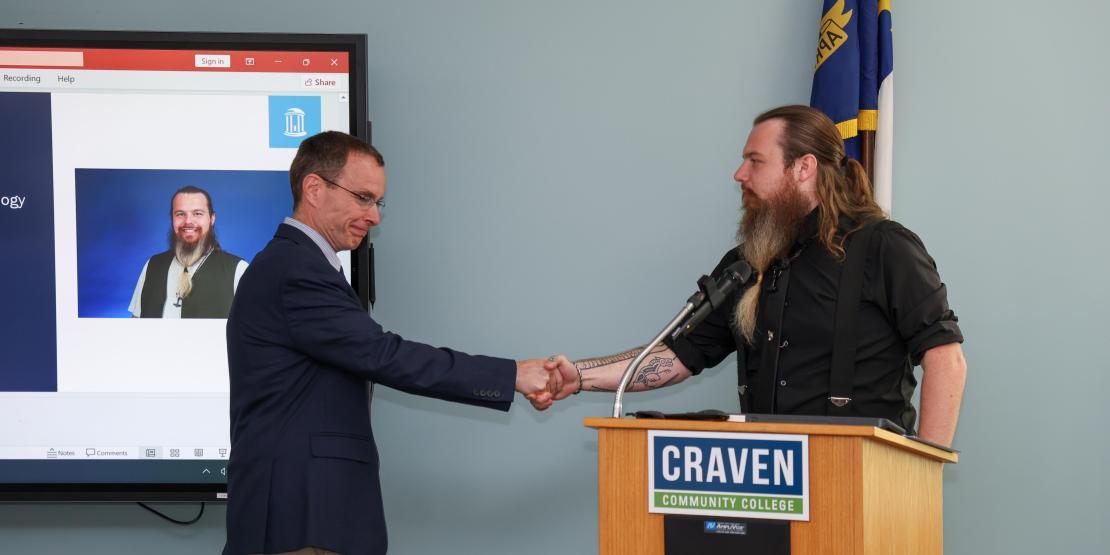Two men shaking hands at Craven Podium