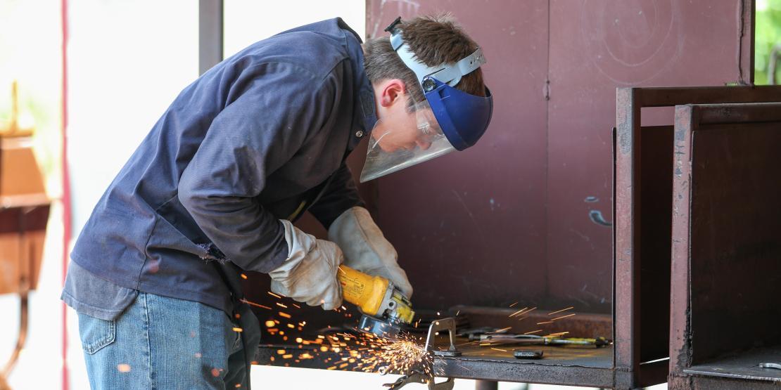 Student with face shield is welding