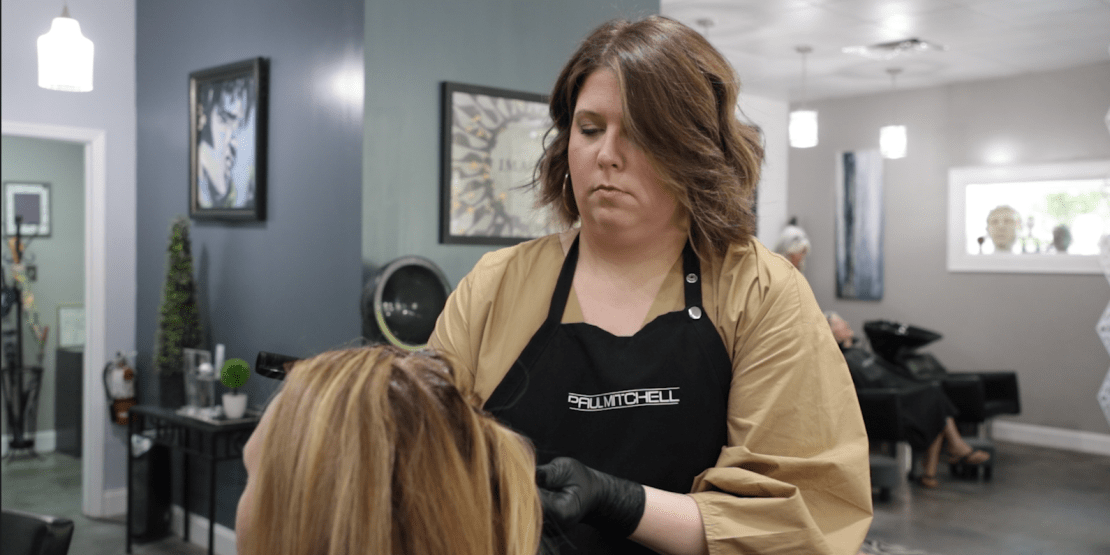 woman cutting and styling hair