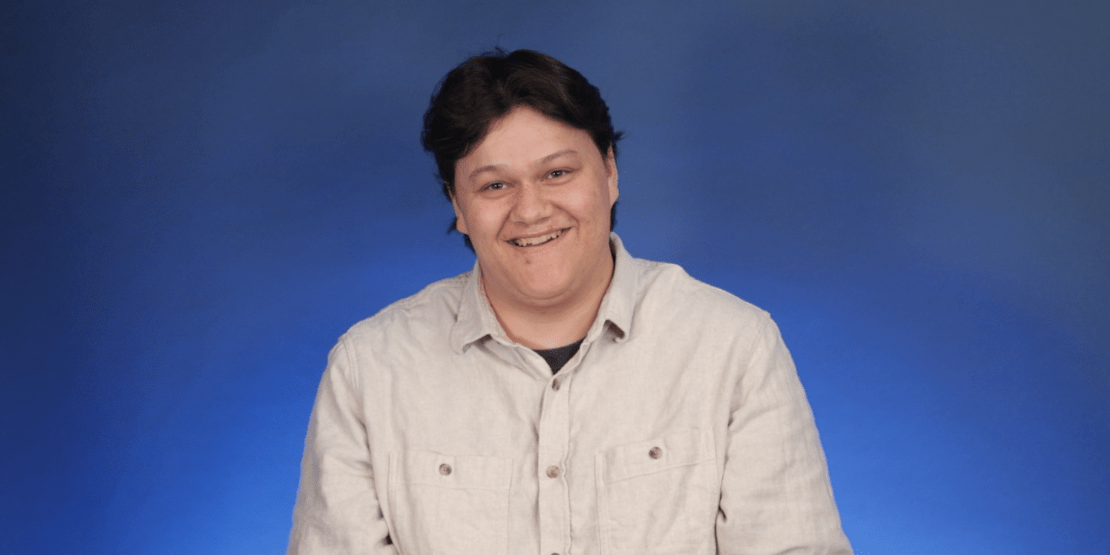 Man stands in front of blue background