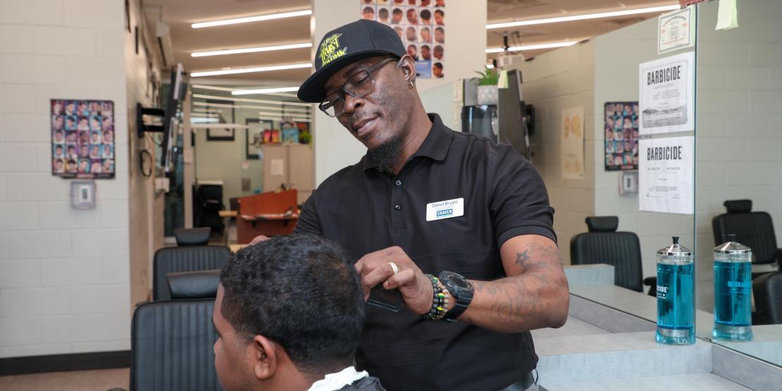 barber cuts a customer's hair