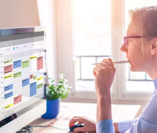 Female IT worker looks at calendar software