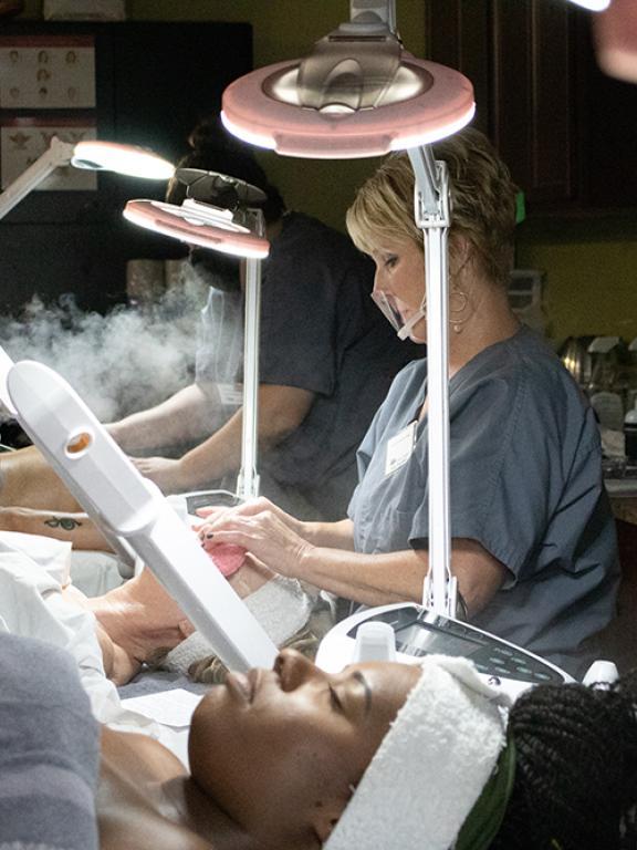 esthetician students performing facials