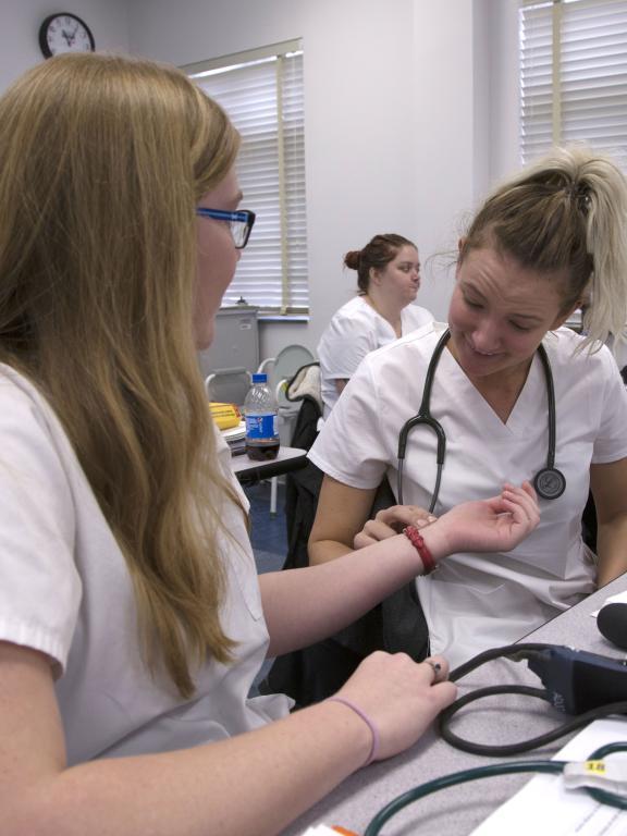 Nursing students practice taking heart rates