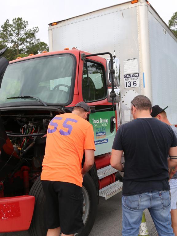 CDL students troubleshooting big rig issues