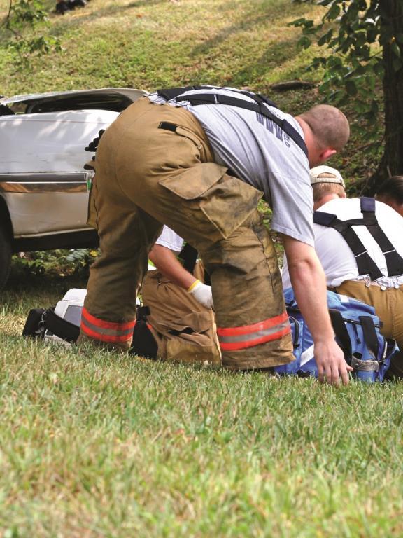 Emergency medical responders help victim of car crash