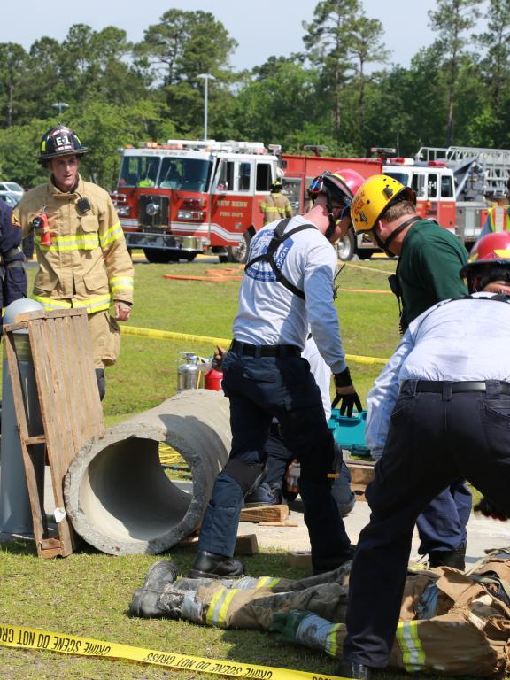 Firefighters next wooden pallets during casualty drill