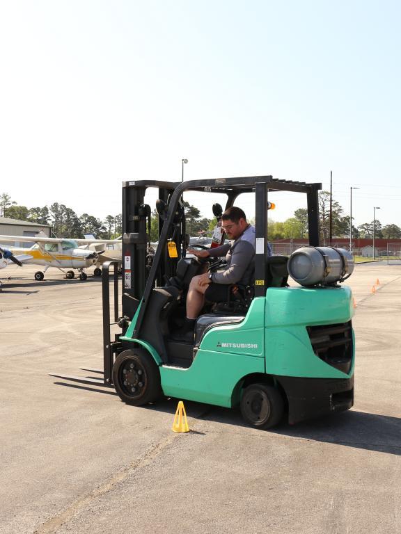Student practices driving a forklift