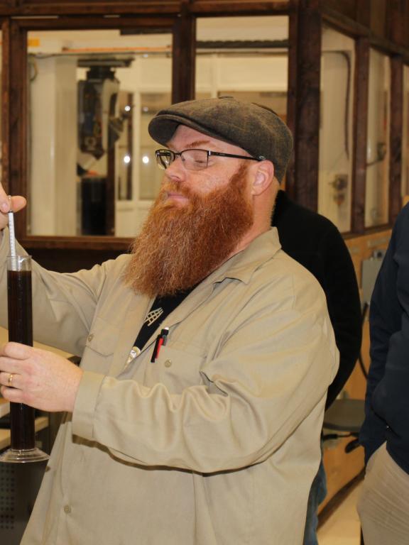 Homebrewing instructor demonstrates basic brewing techniques