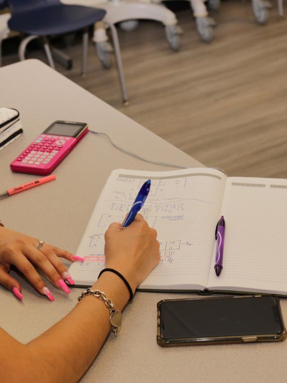 Female student writing in notebook