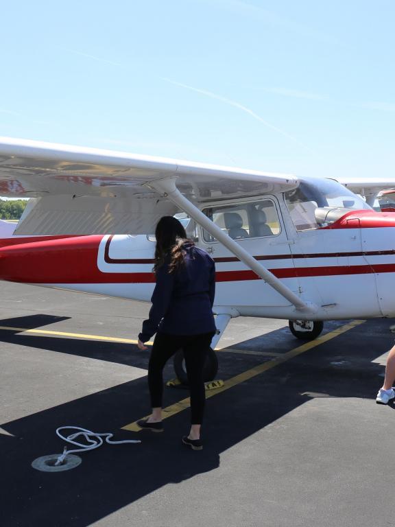 Two aviation students check on two-seater plane