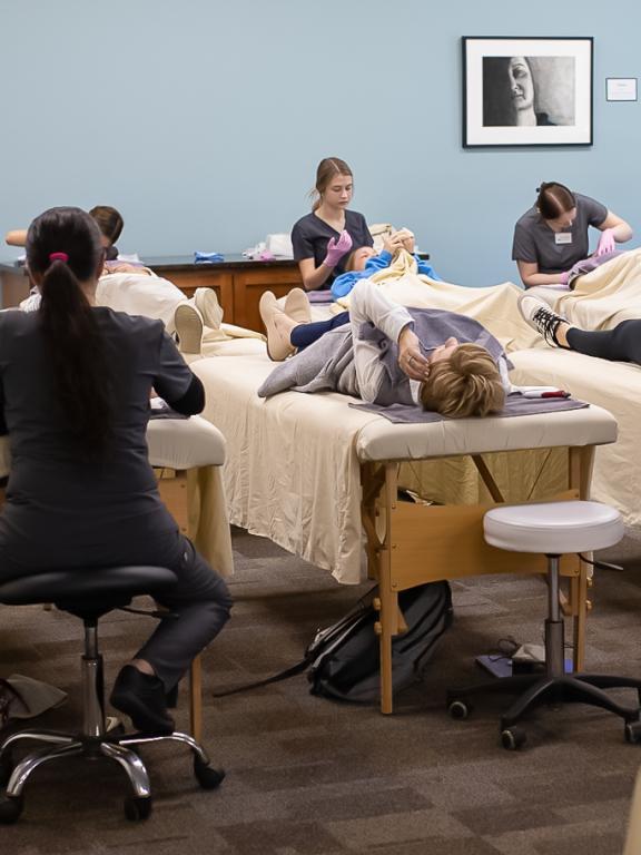 Students in the Esthetics Technology program give patients facials