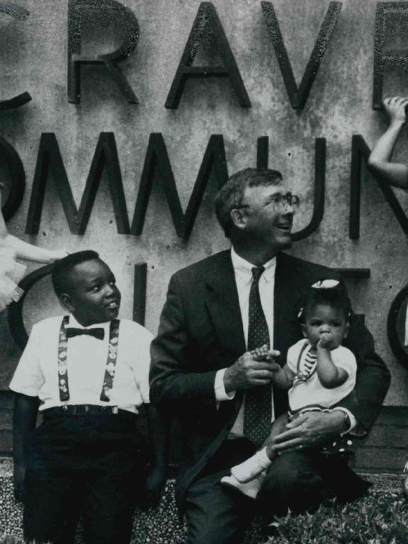 Dr. Steve Redd with children by Craven sign