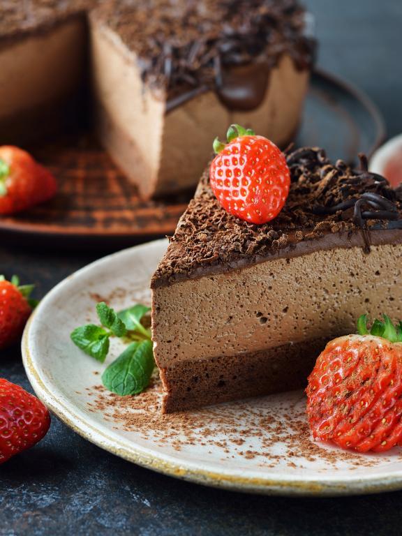 Chocolate mousse cake decorated with strawberries 