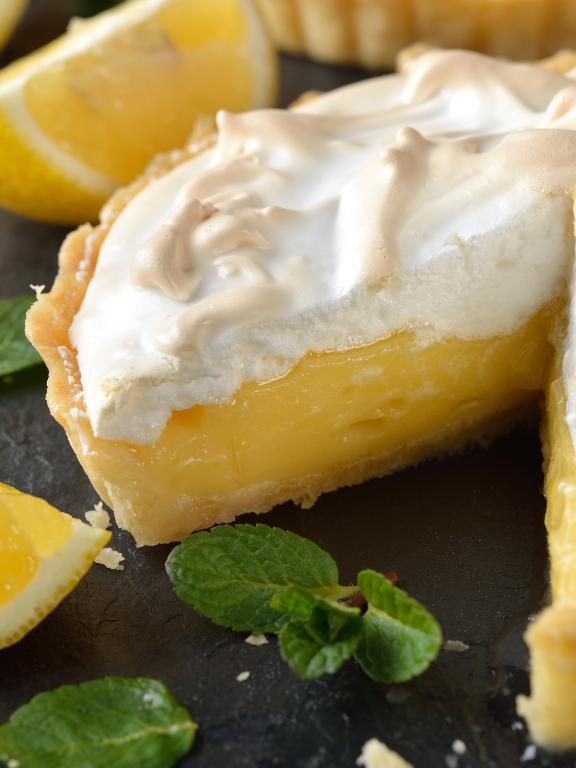 Lemon pie with meringue with lemon wedges