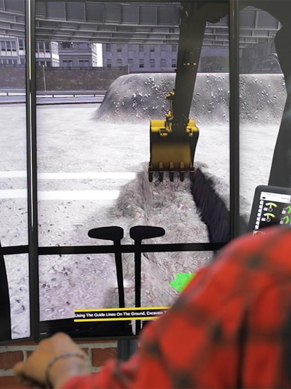 Man uses excavator simulator